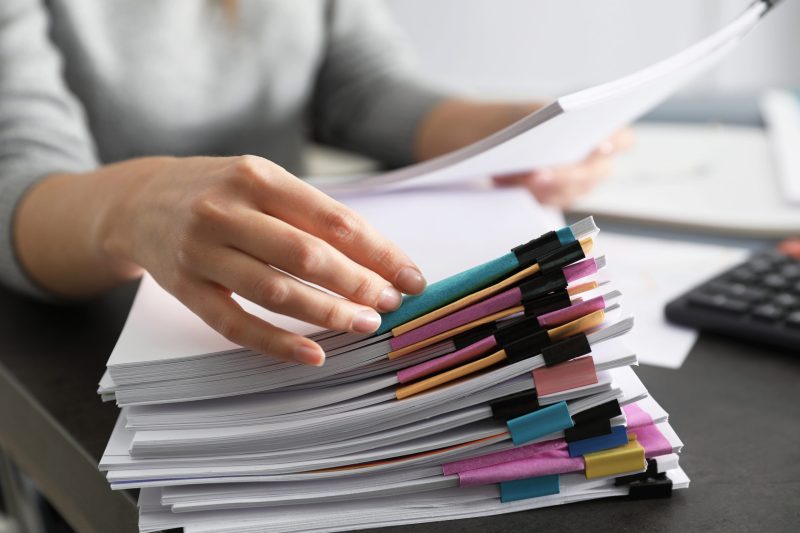 office-employee-working-with-documents-at-table-closeup