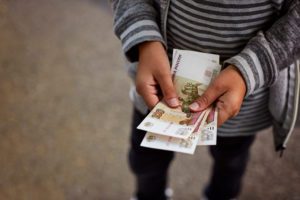 boy-considers-russian-money-notes-on-100-rubles